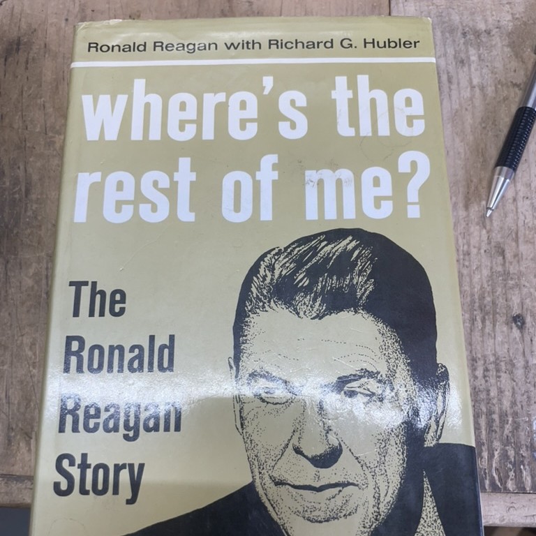 Signed hardcover of Ronald Reagan's 1965 memoir "Where's the Rest of Me?" (with Richard G. Hubler) on the SellBooksABQ sorting bench — a recent signed book we bought, listed, and sold.